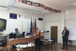 Participant identifying security features in a passport during the advanced training course on the detection of forged documents, Skopje, 18 October 2019.  (OSCE/Angelisa Corbo)