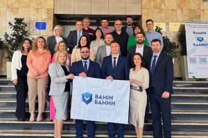 Participants pose for a handover of the BAMIN Presidency from Moldova to North Macedonia, with the traditional signature of the BAMIN Flag, Skopje, 29 May 2024. (BAMIN)