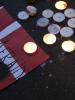 Denmark's flag is seen next to candles, paying tribute to the victims of the deadly attacks in Copenhagen, February 15, 2015. (REUTERS)