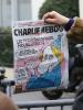 After a fatal shooting at the Paris offices of the satirical newspaper Charlie Hebdo, a member of the media makes images of the front page of the magazine nearby, 7 January 2015. (REUTERS/Jacky Naegelen )
